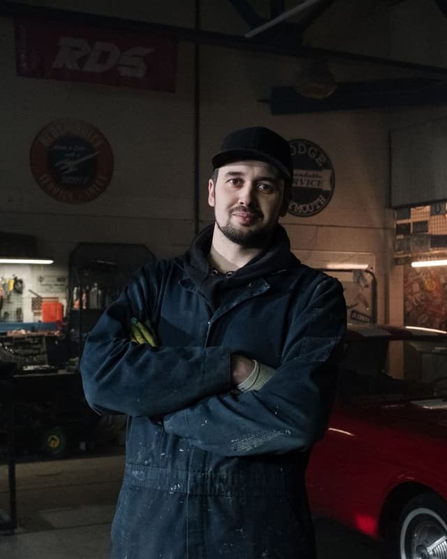 Stock photo: a technician standing in a garage; this is not the owner