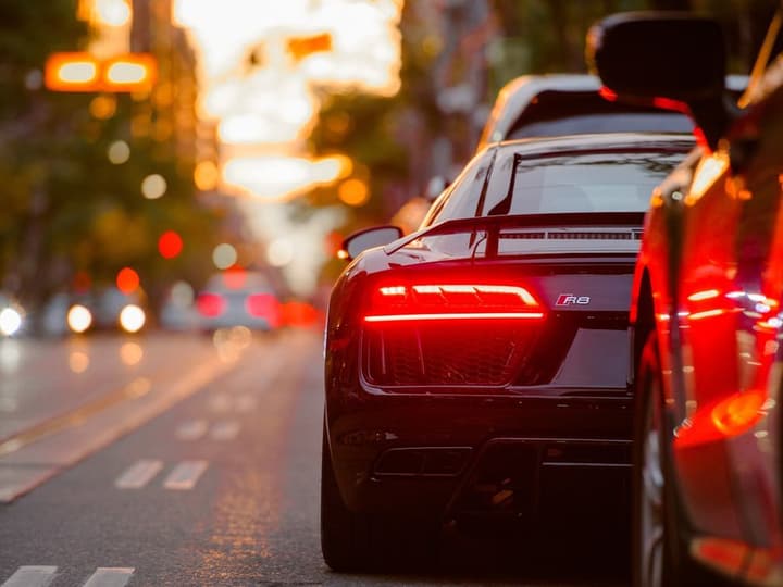 Stock photo: a car's rear body panel and taillight at dusk
