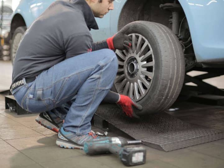 Stock photo: a technician mounting a wheel
